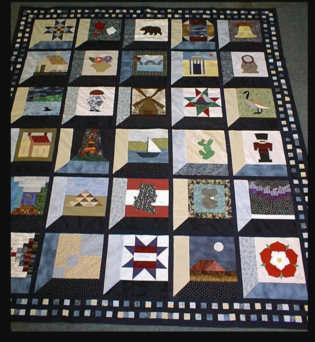 Cheryl's finished quilt from the Twenty Plenty International swap — blocks from quilters around the world in an attic-window setting