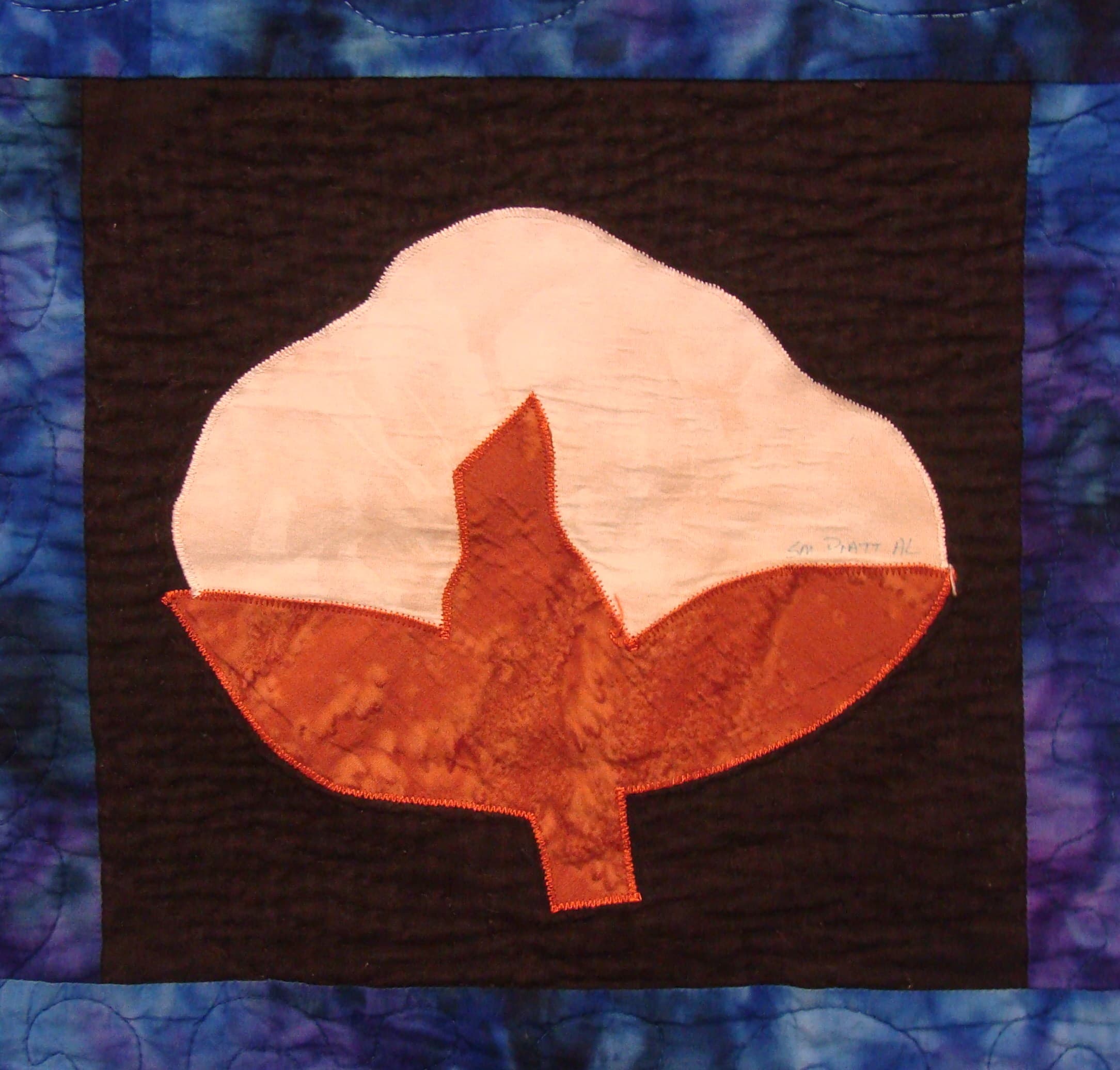 NF12 — Batik & Fossil Fern on Black quilt block