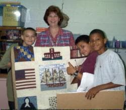 Donald presenting quilt to Mrs. Parks' classroom